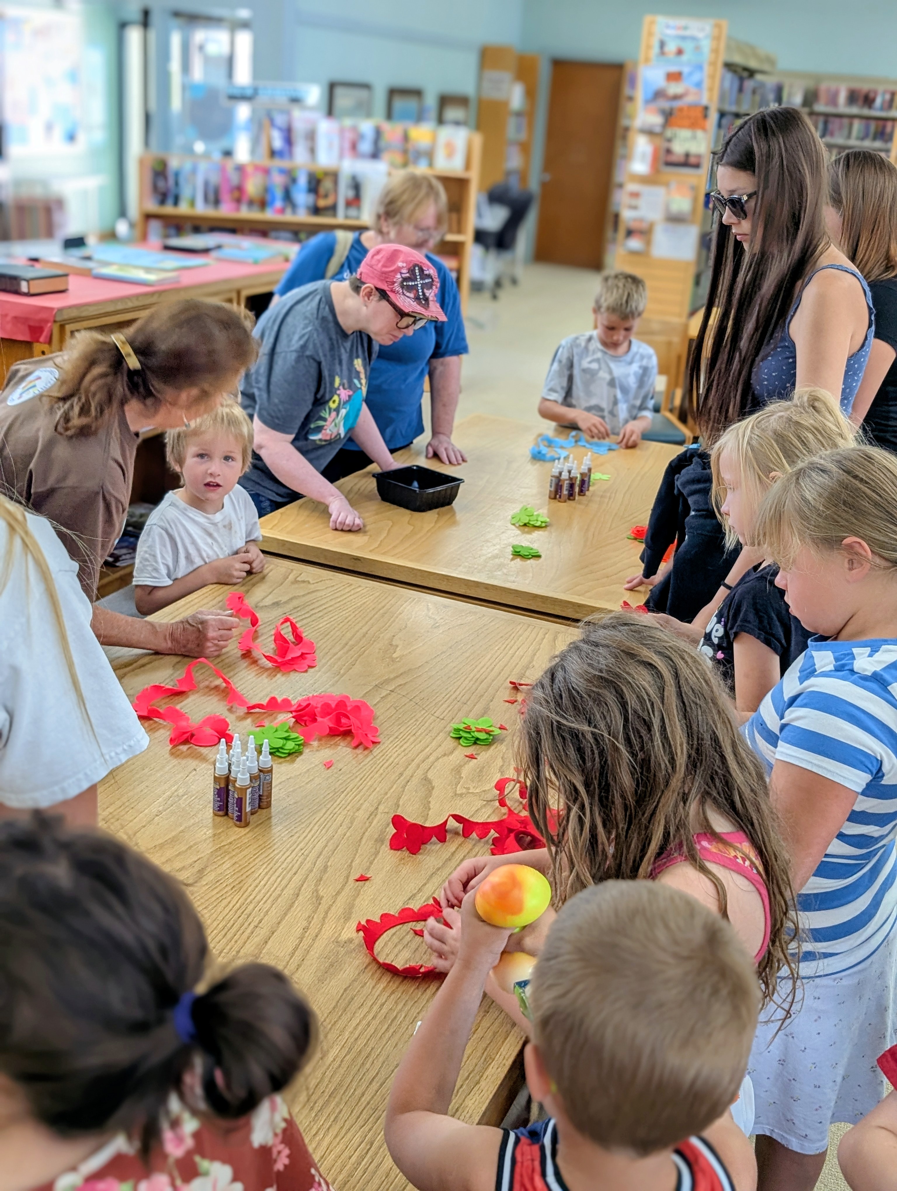 Sheep arts IYRP exhibit at Harney County Library. Cutting out flowers.